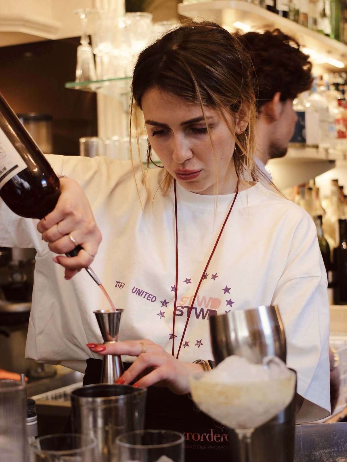 Allieva prepara un cocktail durante il corso di mixology